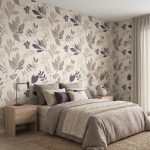 Bedroom with beige floral wallpaper, a bed with taupe bedding and multiple throw pillows, and wooden nightstands on either side.