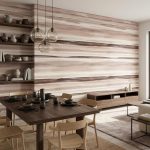 Modern dining room with a dark wooden table, light chairs, and a striped beige feature wall with open shelving on the left.