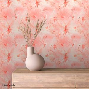 Pastel pink wallpaper with whimsical silhouettes and butterflies; a round beige vase with dried branches sits on a wooden dresser.
