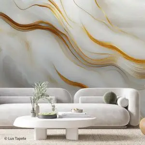 Modern living room with a white curved sofa, round coffee table, and an abstract gold-gray wall mural behind.